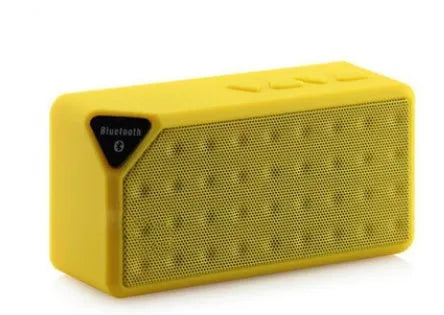 Cannon X3 small cube-shaped wireless Bluetooth portable speaker shown in one of five colours: black, blue, green, red, or yellow.