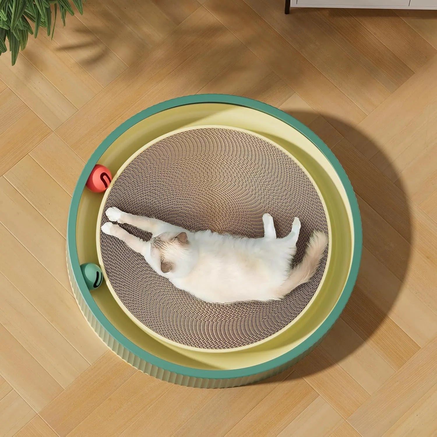 Large green cat scratching board with interactive ball toys showing refillable core design