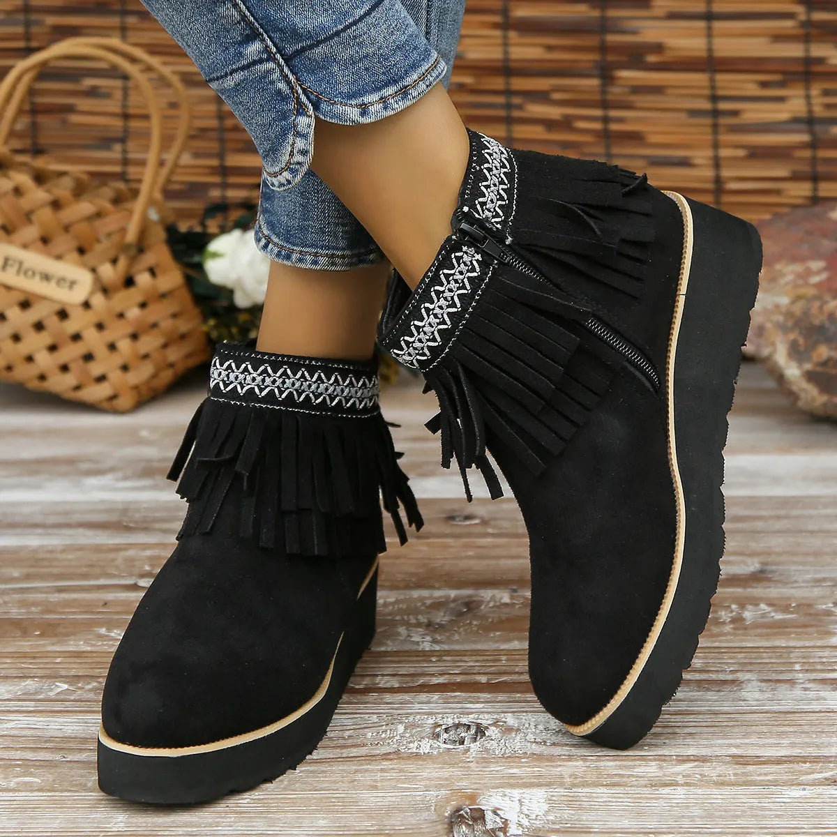Women's suede ankle booties with a wedge heel, side zipper, tassel detail, and thick rubber sole.