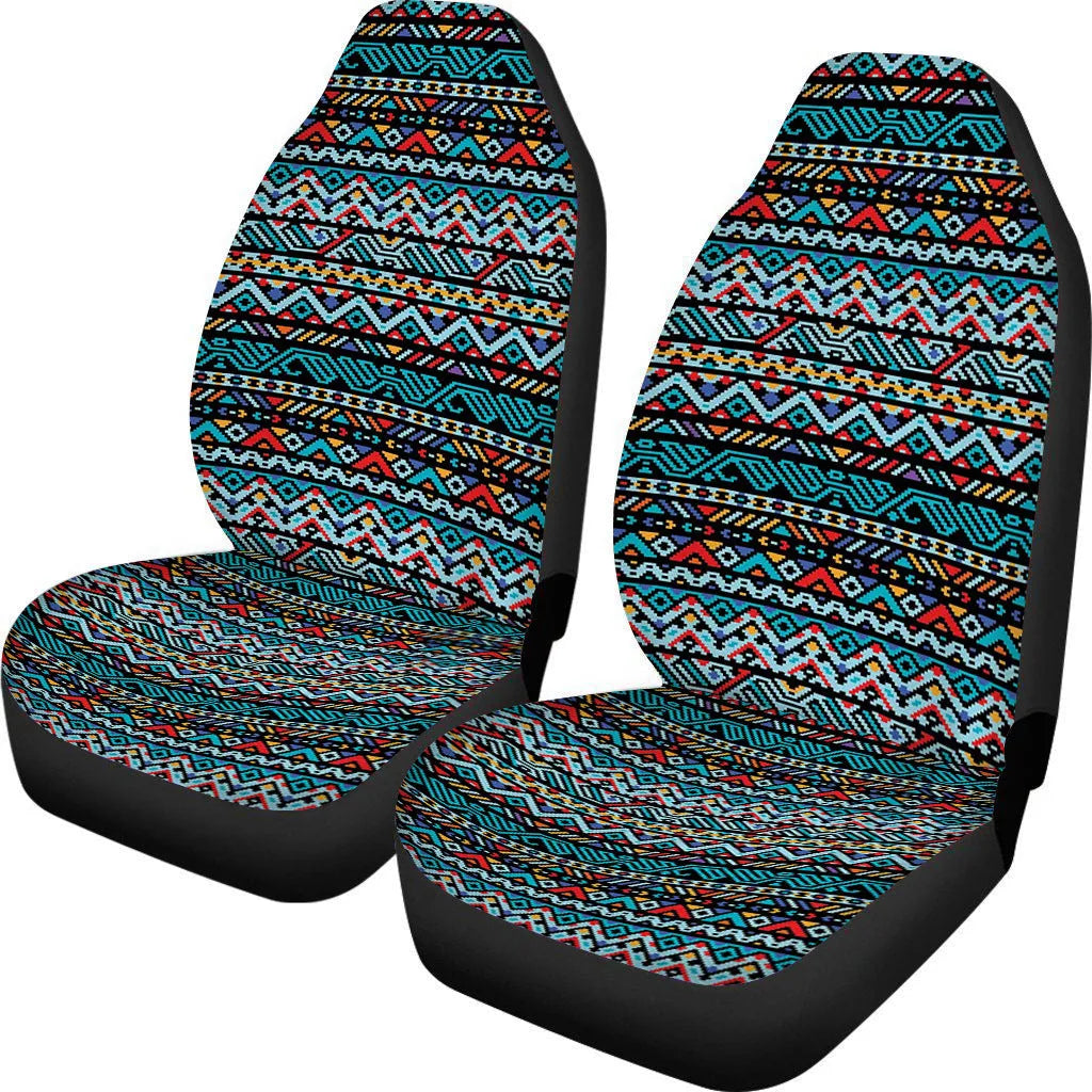 Pair of universal car seat covers in a cow spot leopard print retro pattern on a car front seat.