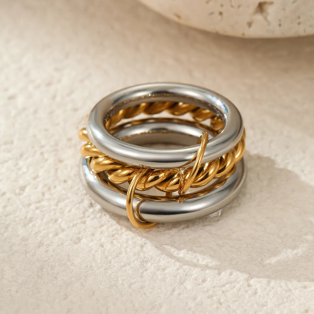 Stacked stainless steel ring set with 18K gold plating, exaggerated design for women.