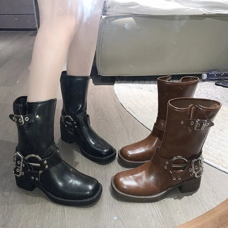 Women's black platform boots with belt buckle decoration at mid-calf length