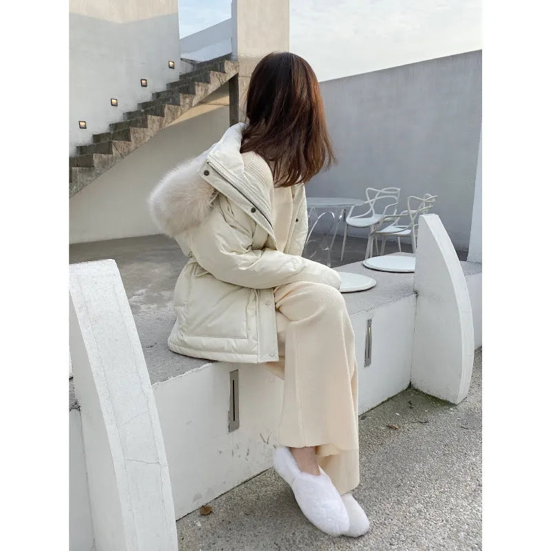 Women's high-waist knitted wide-leg trousers in cream white, showing straight-leg cut and drooping hem.