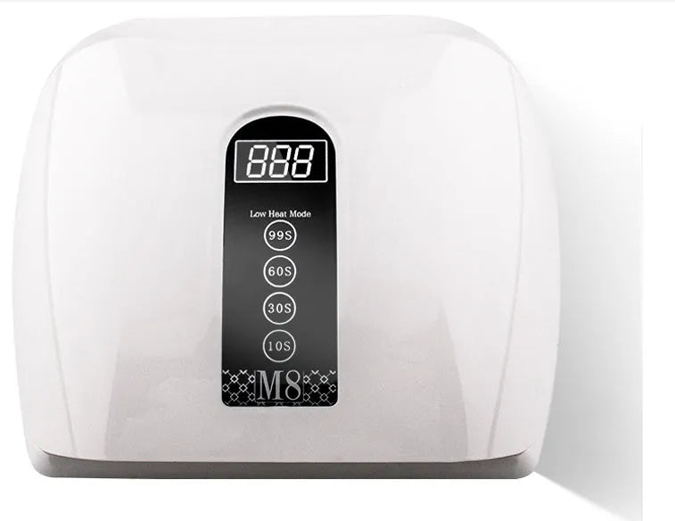 White 96W LED nail dryer with red light, 48 lamp beads, and removal base tray on a desk