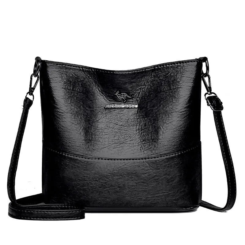 Women's soft leather bucket shoulder bag in black with minimalist design and interior phone pocket