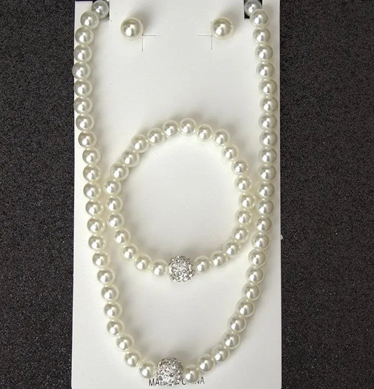 White plastic resin pearl-style jewellery set including necklace, earrings, and bracelet on display