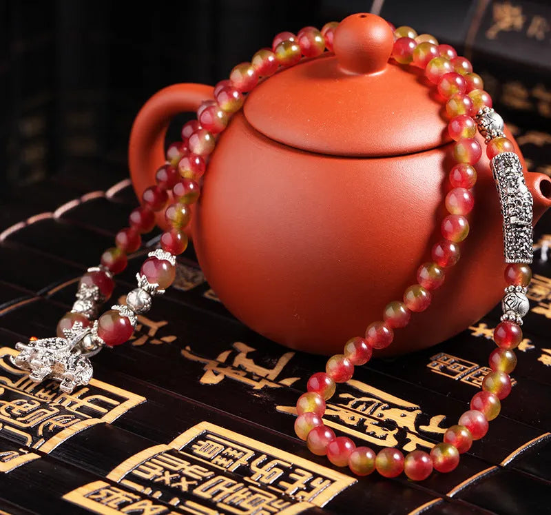 Handmade watermelon crystal Chinese knot bracelet with traditional geometric designs in 8mm and 6mm elephant style sizes