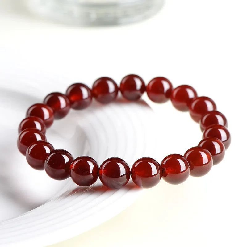 Crystal bracelet with natural orange red garnet beads and traditional Chinese ruyi charm in retro unisex design
