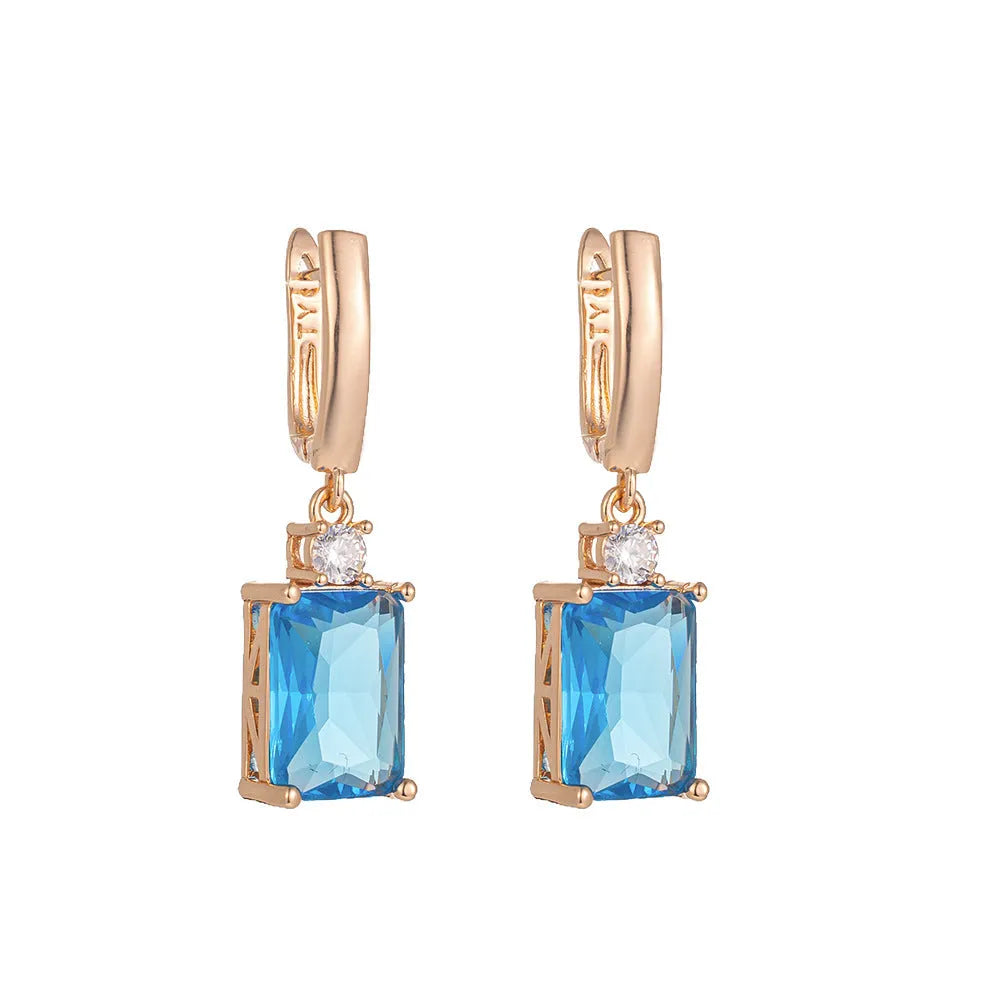 A pair of square gold and silver geometric electroplated earrings with a quadrilateral design.