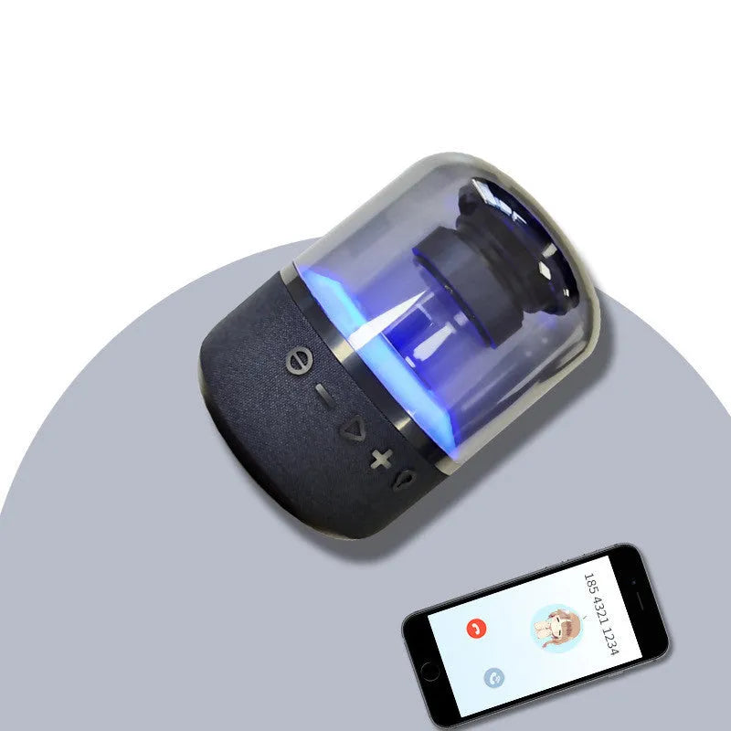 Four-colour light touch wireless Bluetooth speaker with halo lighting effect on a table.
