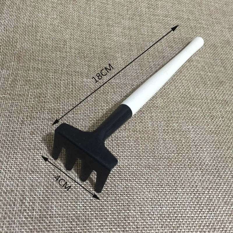Succulent gardening tool set with plastic watering can, mini shovel, rake, tweezers, and a small bucket on a table