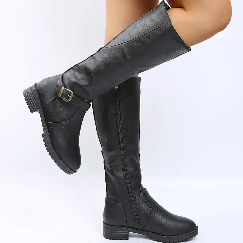 Women's solid colour knight boot with buckle detail, round toe, and square rubber heel.