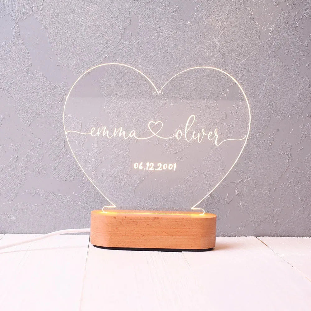 Personalised acrylic night light with engraved names and date, measuring 20cm by 11.5cm