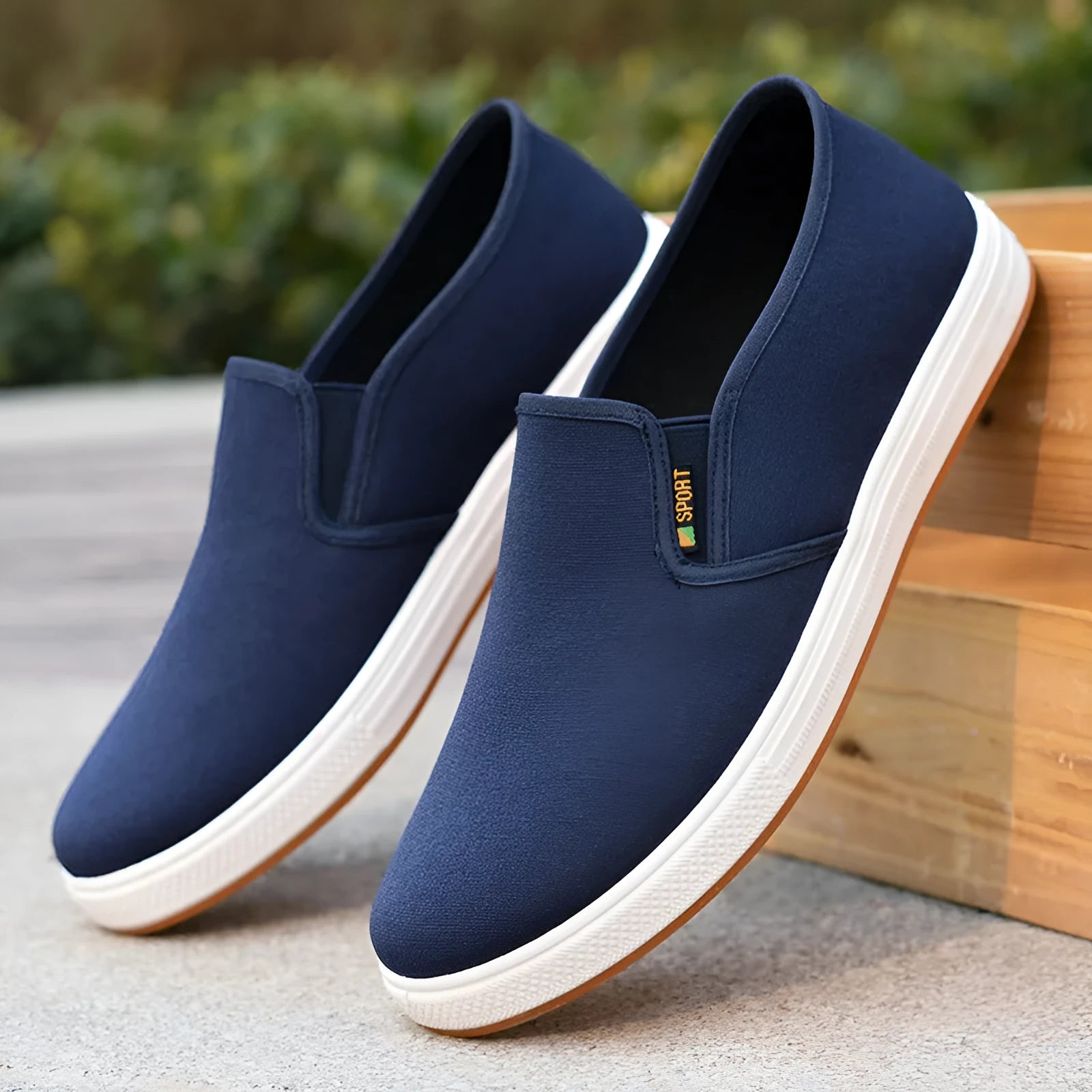 Men's black and blue slip-on canvas trainers with round toe and shallow mouth design