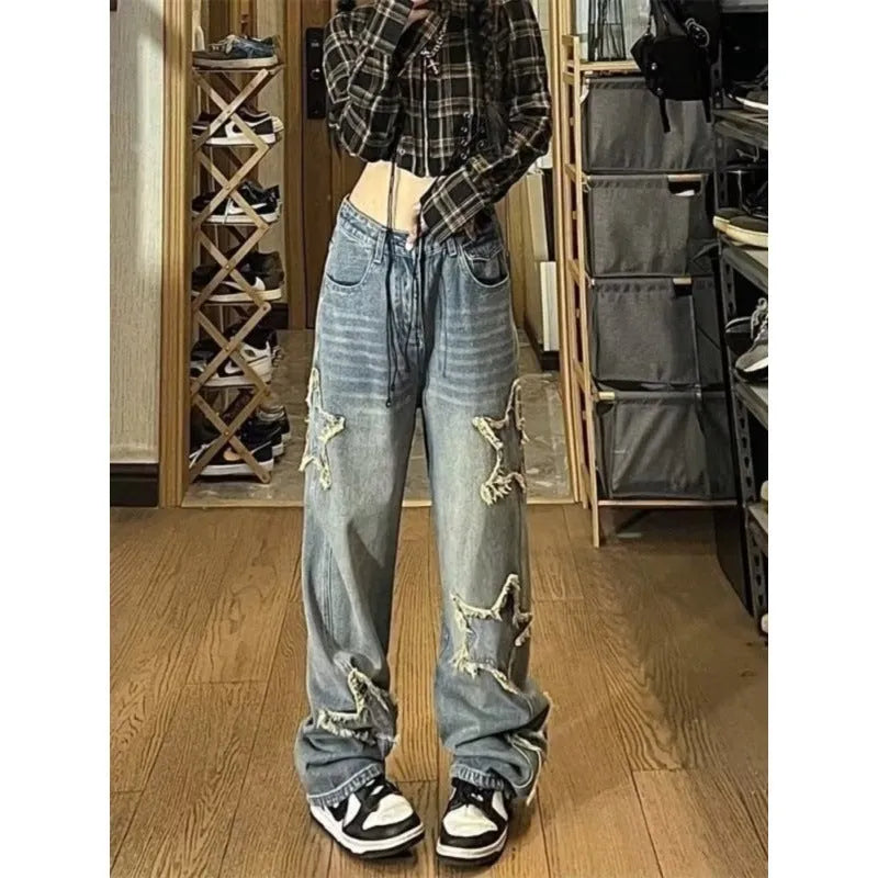 Blue high-waisted wide-leg denim pants with straight-leg silhouette on hanger