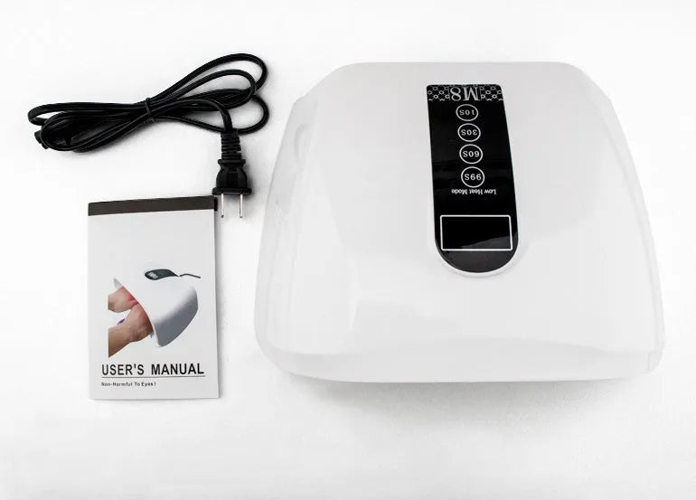 White 96W LED nail dryer with red light, 48 lamp beads, and removal base tray on a desk