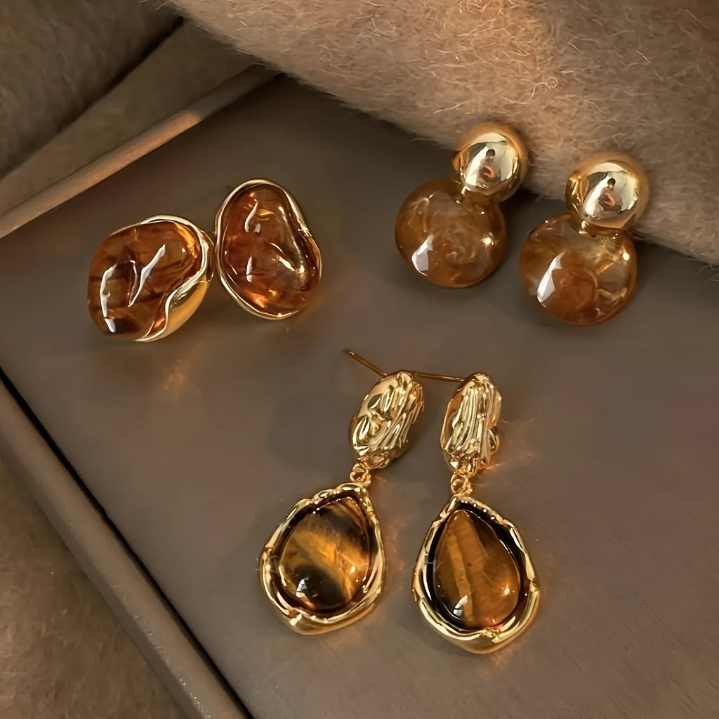 Handmade geometric holiday ear ring set showing three styles with tassel elements in different designs