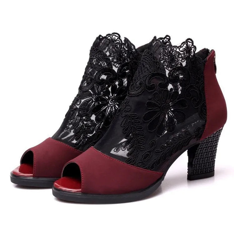 Black women's lace gladiator sandals with a zip closure, floral pattern, and a square high heel on a rubber outsole.