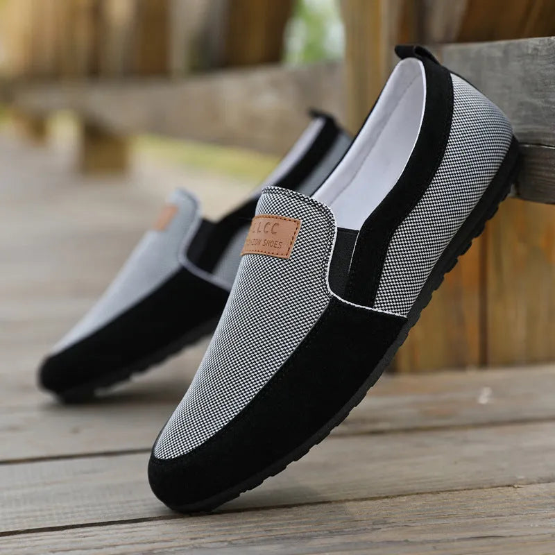 Men's grey canvas lace-up board shoes with round toe and rubber sole on a white background.