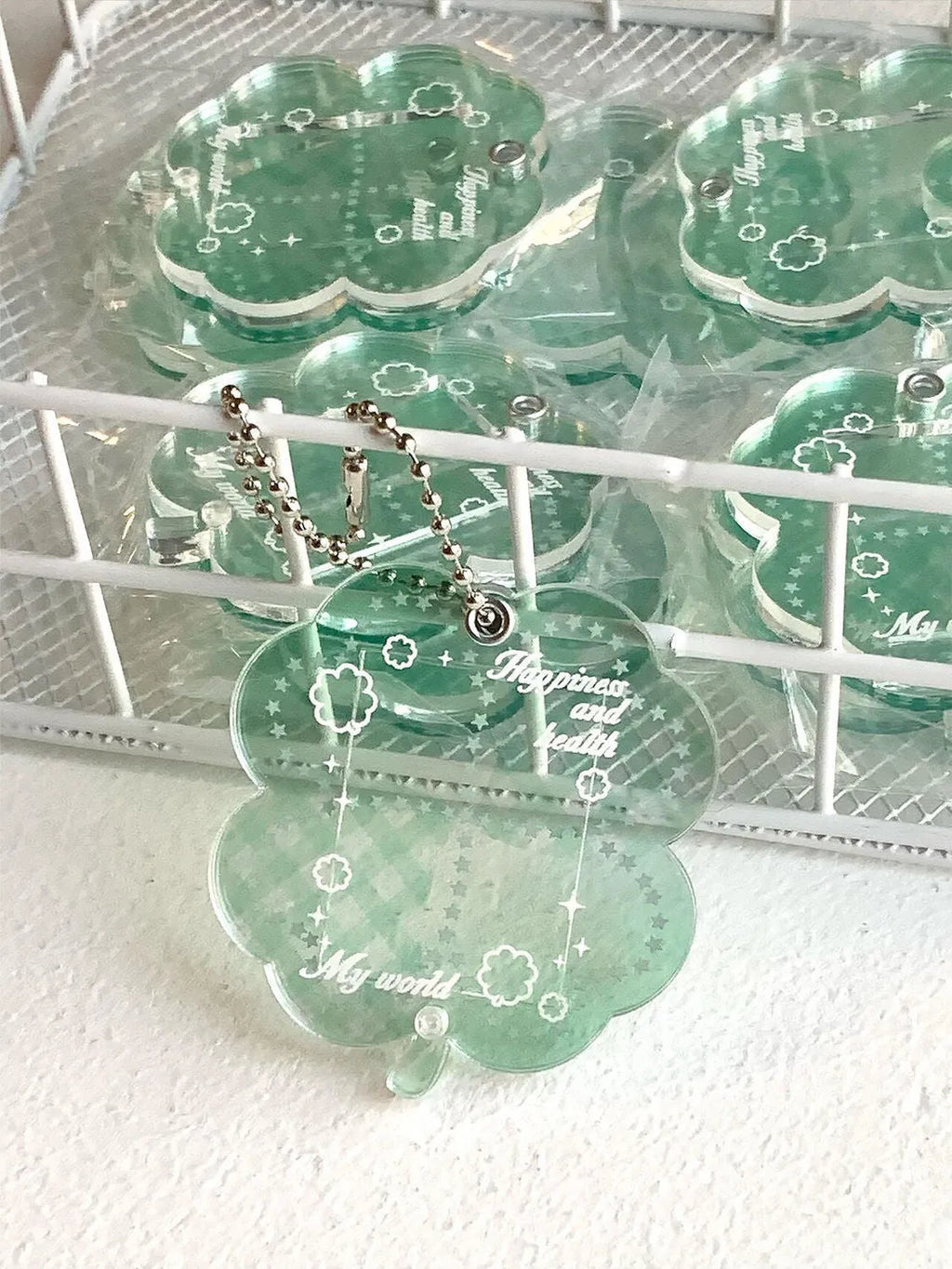 Acrylic four-leaf clover pendant keychain for phones in blue, green, or mint.