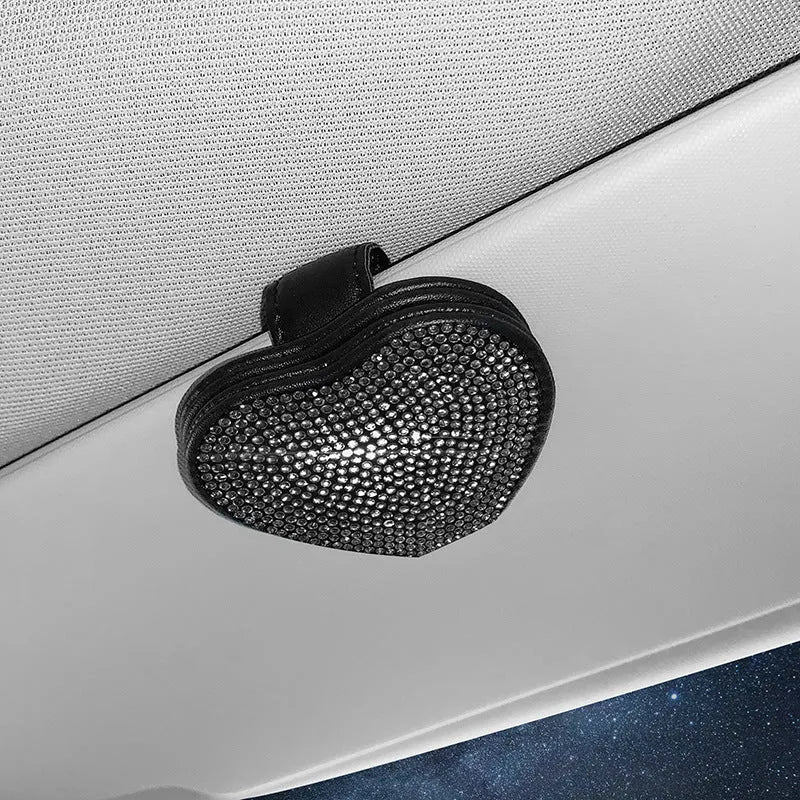 Black diamond-encrusted PU leather car sun visor clip holding sunglasses and a ticket.