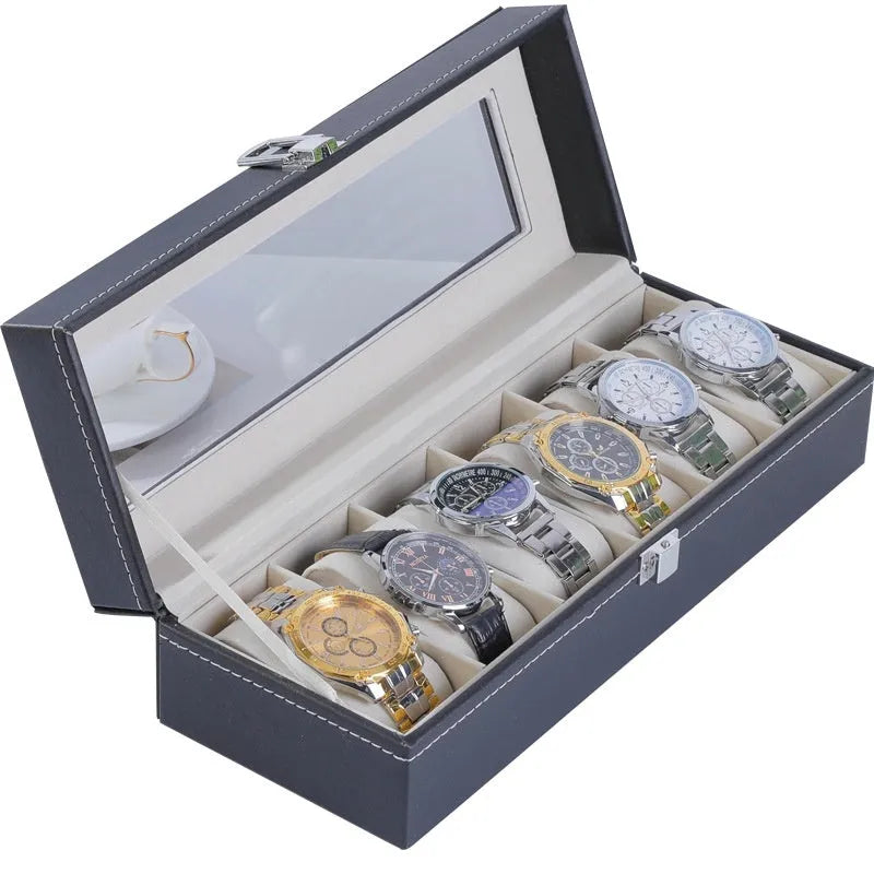 Grey leather watch storage box with see-through lid showing organised watch storage compartments