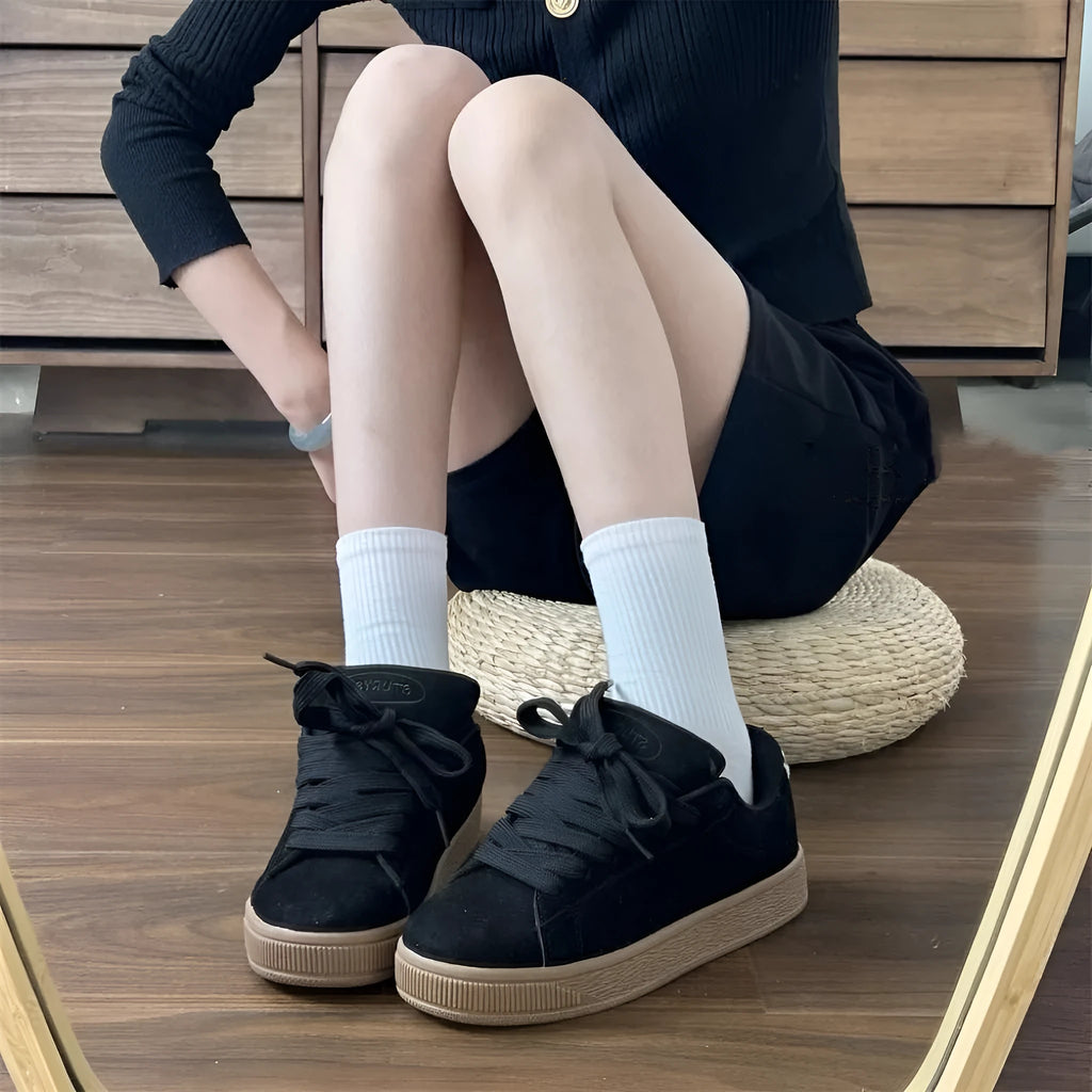 Black retro low-top sneakers with lace-up front, waterproof platform, and round toe design