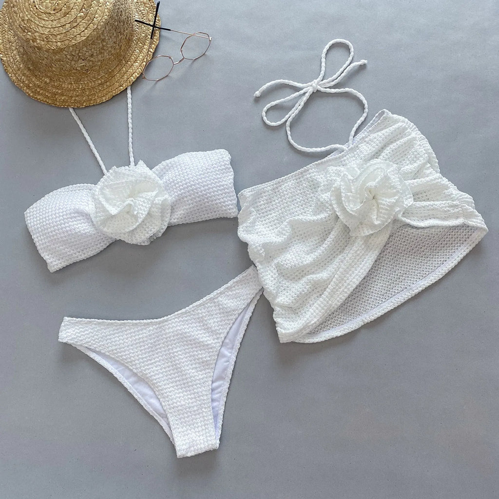 Women's white three-piece bikini with 3D flower split design, showing skirt, bra, and briefs.
