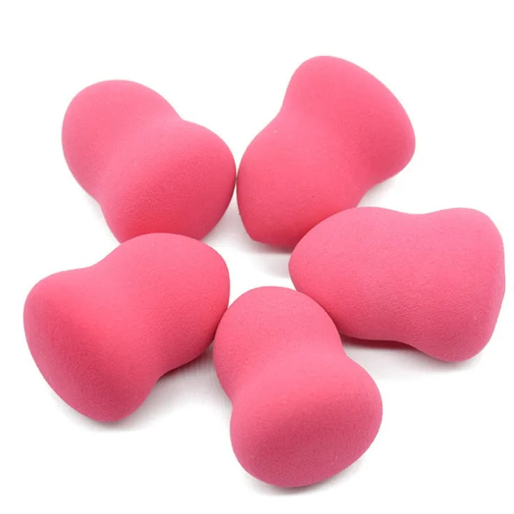 Pink hydrophilic non-latex makeup foundation sponge puff on white background.