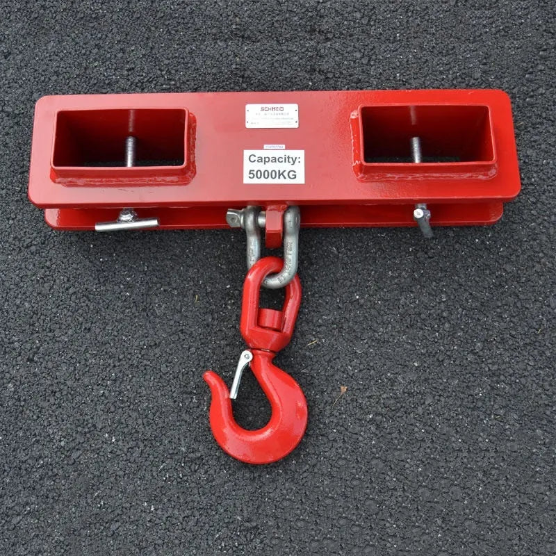 MK forklift crane hook attachment with rotatable drum and safety lock mounted on forklift forks.