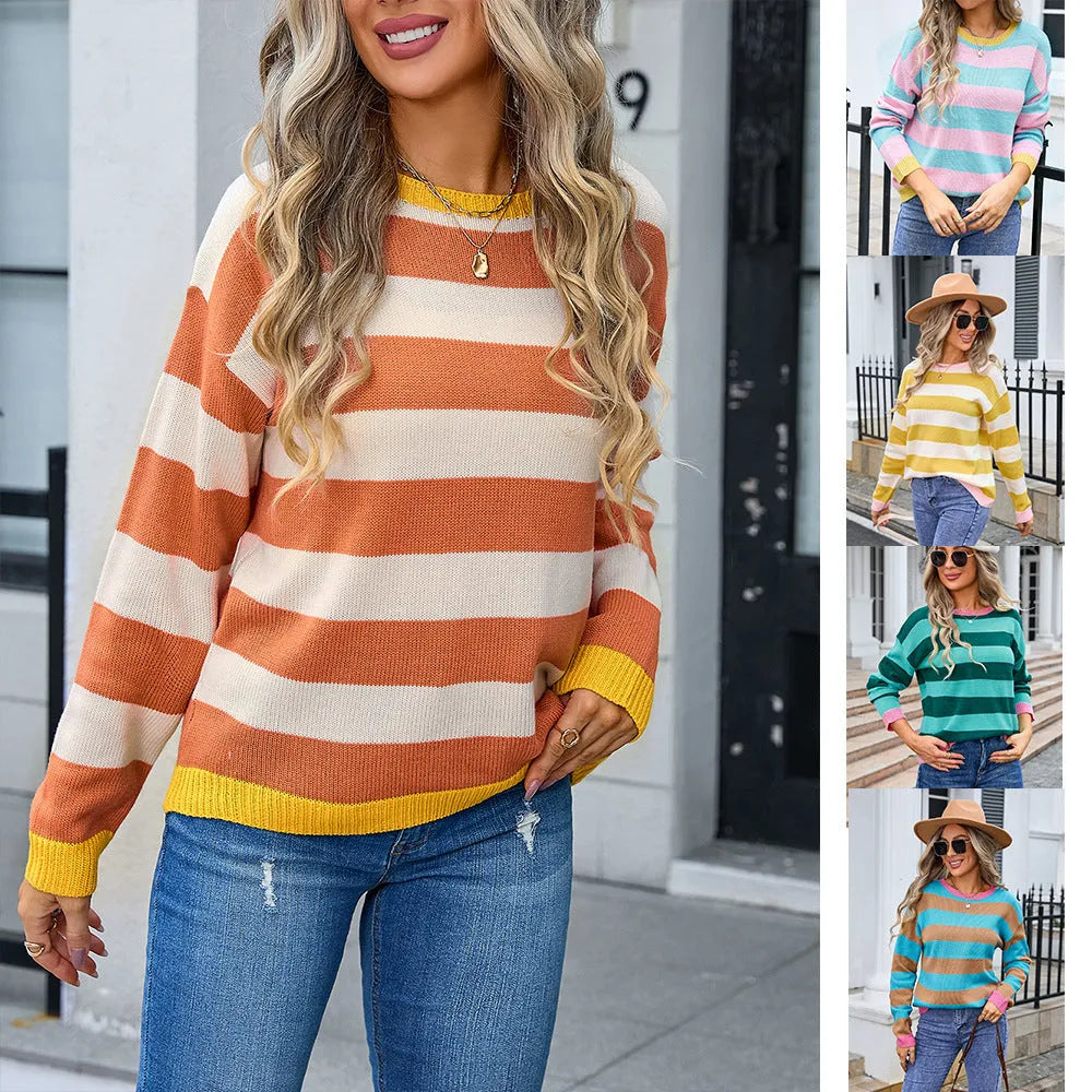 Women's loose blue acrylic knit sweater with round neck and long sleeves on a hanger.