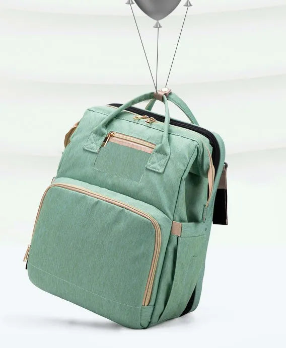 Folding baby bag bed backpack with portable mattress, USB charging option, front pocket, and multiple colour choices