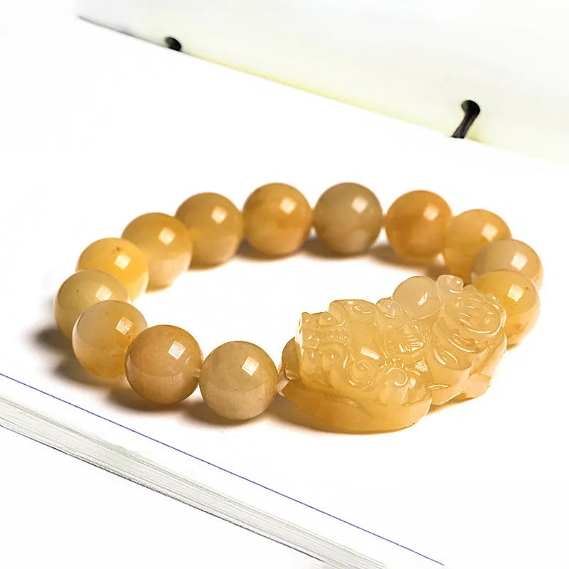 Hand-carved Golden Thread Jade money bracelet showing detailed coin design on round jade beads.