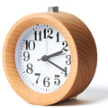 Solid beech wood silent snooze alarm clock with white dial and black numerals on a wooden surface.