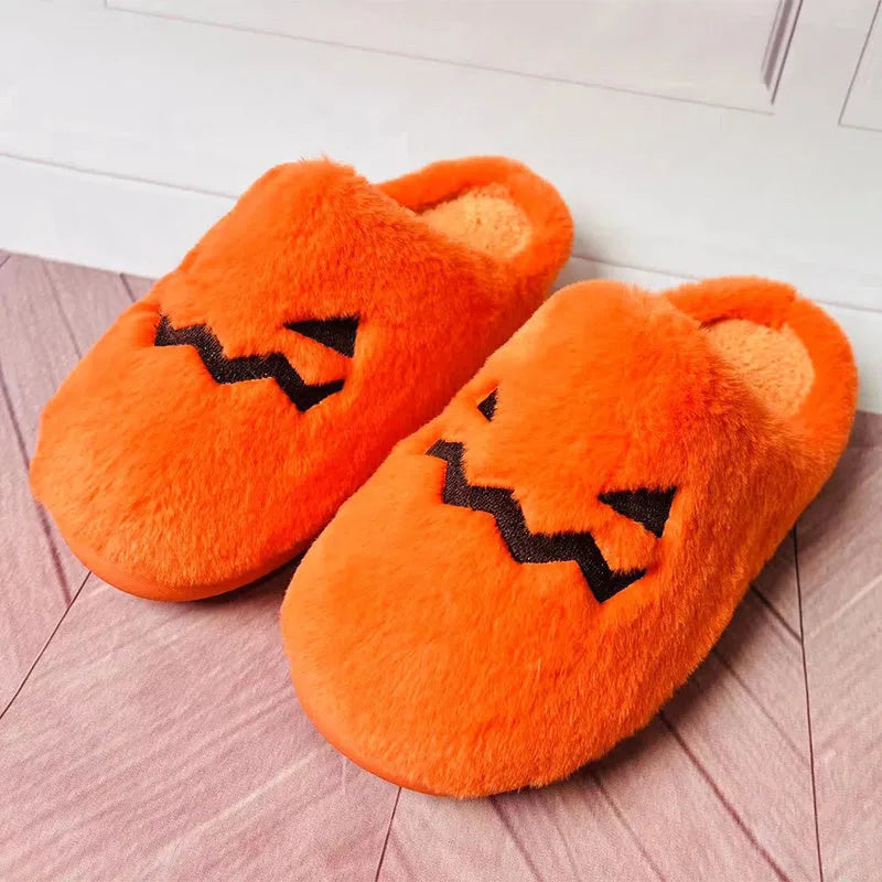 Orange Halloween pumpkin design slippers with plush lining and a textured PVC sole.