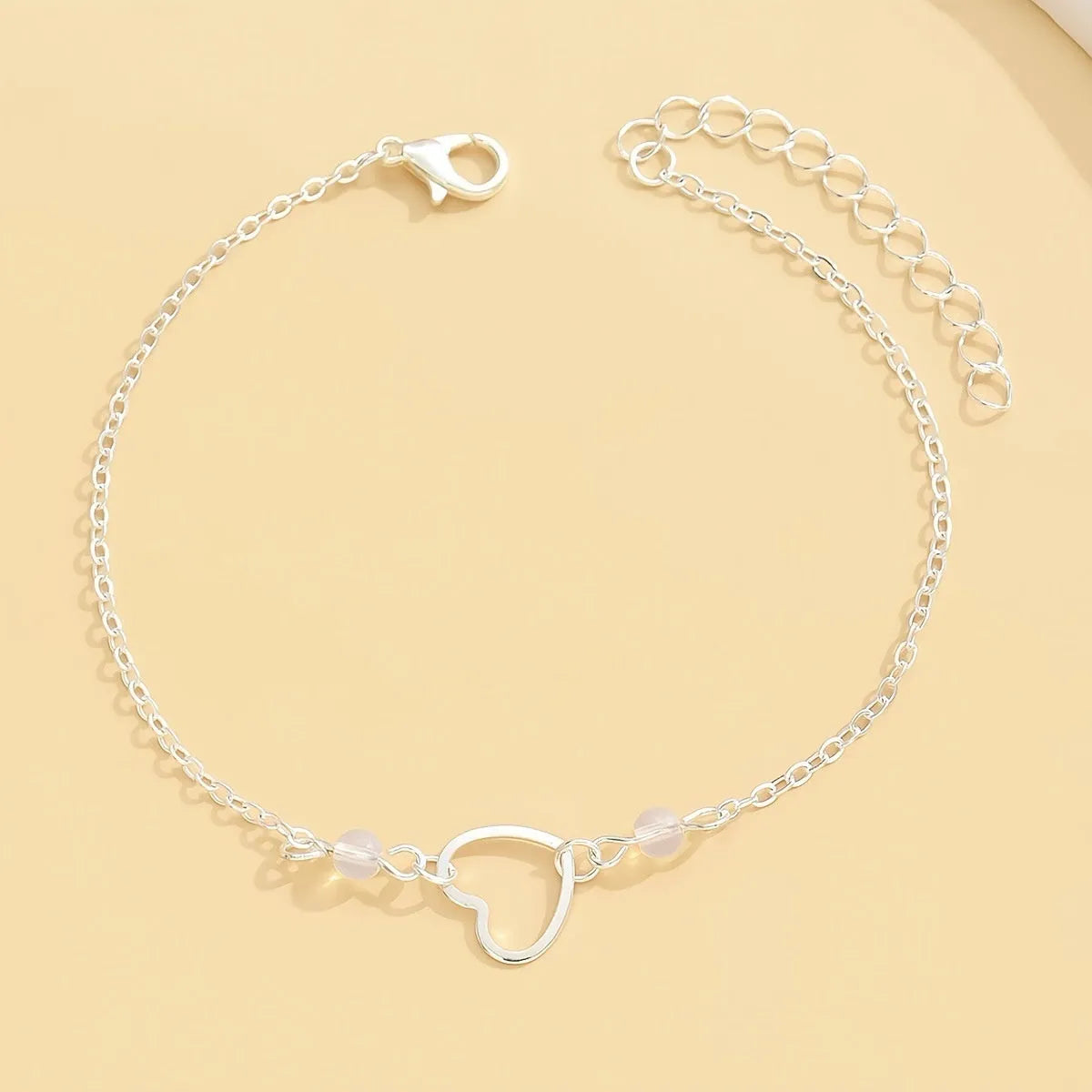 Women's adjustable anklet with geometric heart pendant in gold or silver tone