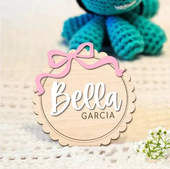 Square wooden baby room ornament personalised with a name, shown in 13cm and 15cm sizes.