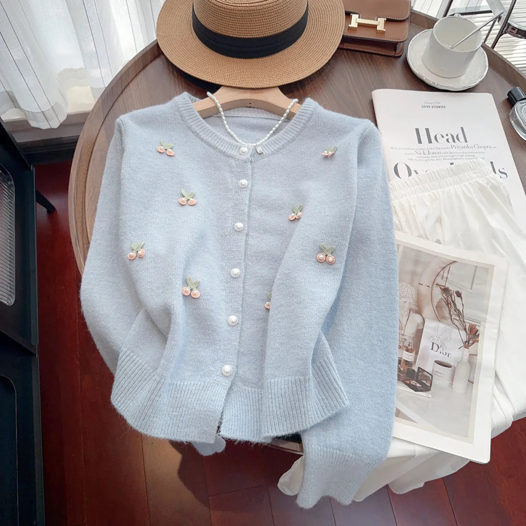 Slim-fit cashmere blend sweater coat with beaded detail on a hanger, shown in blue colour.