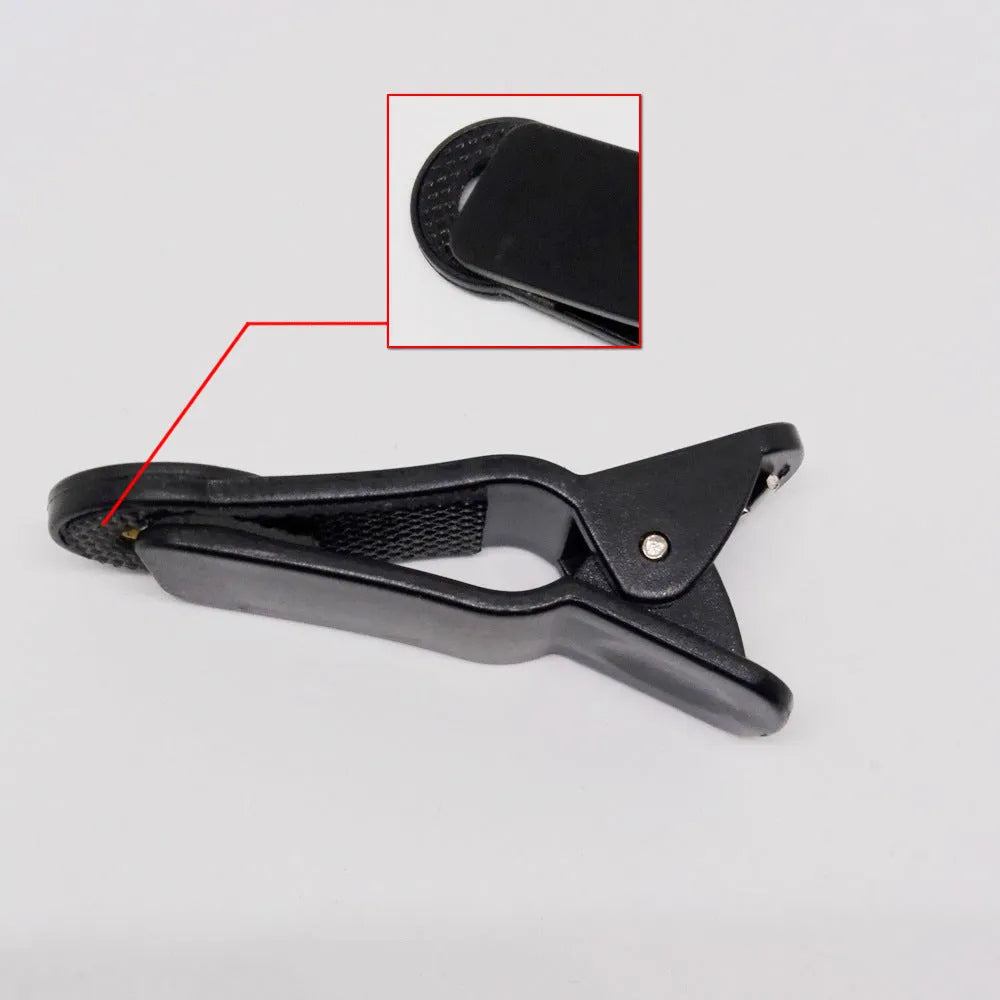 Silver telescopic phone camera lens with extended barrel next to a universal clip mount on a white background.