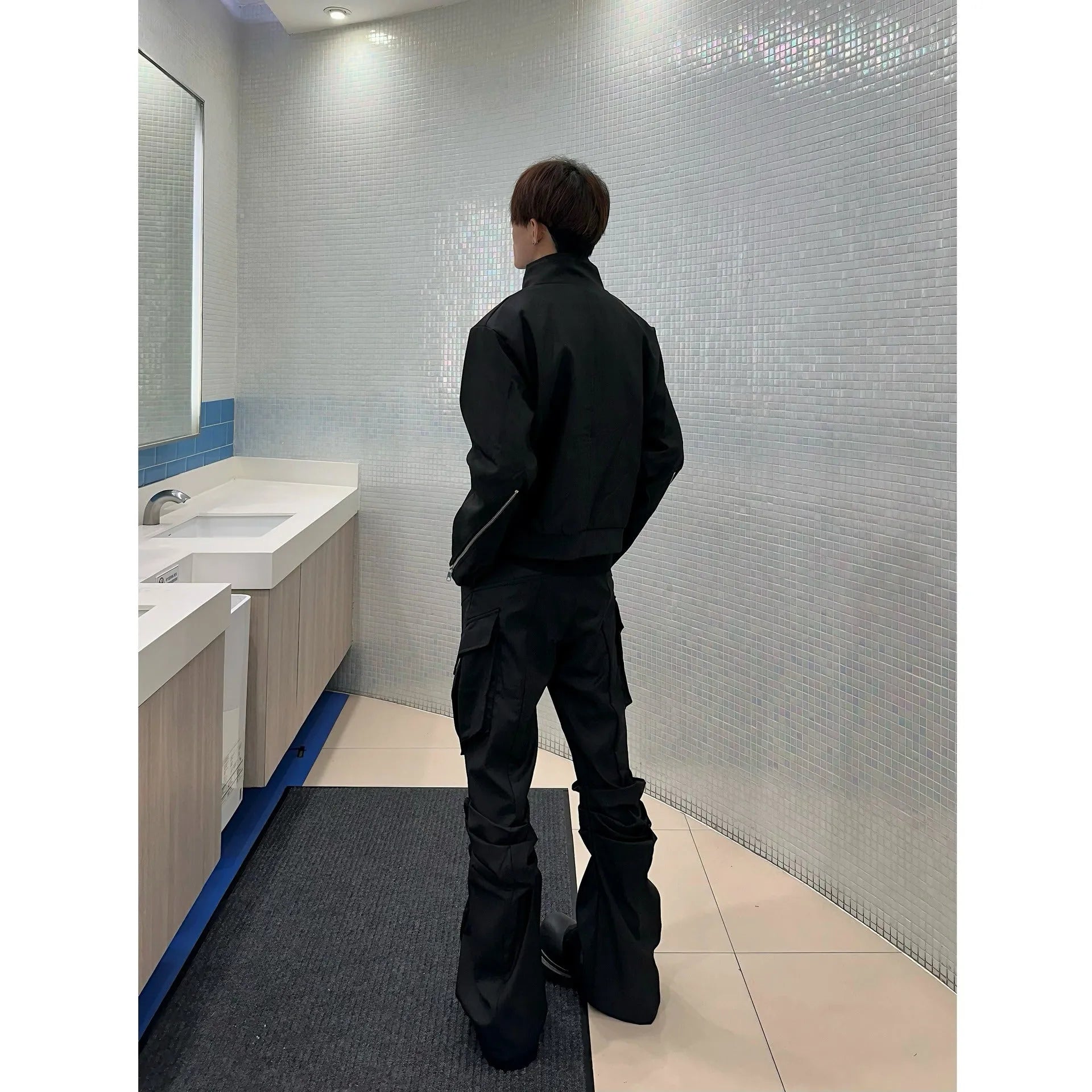 Men's black cargo trousers with large side pockets, straight-leg cut, on a plain background