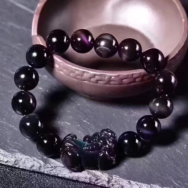 Natural ice colour eye obsidian crystal bead bracelet with spherical beads on wrist.