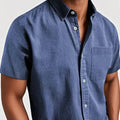 Men's loose fit short sleeve cardigan shirt in a cotton blend fabric, shown on a hanger.