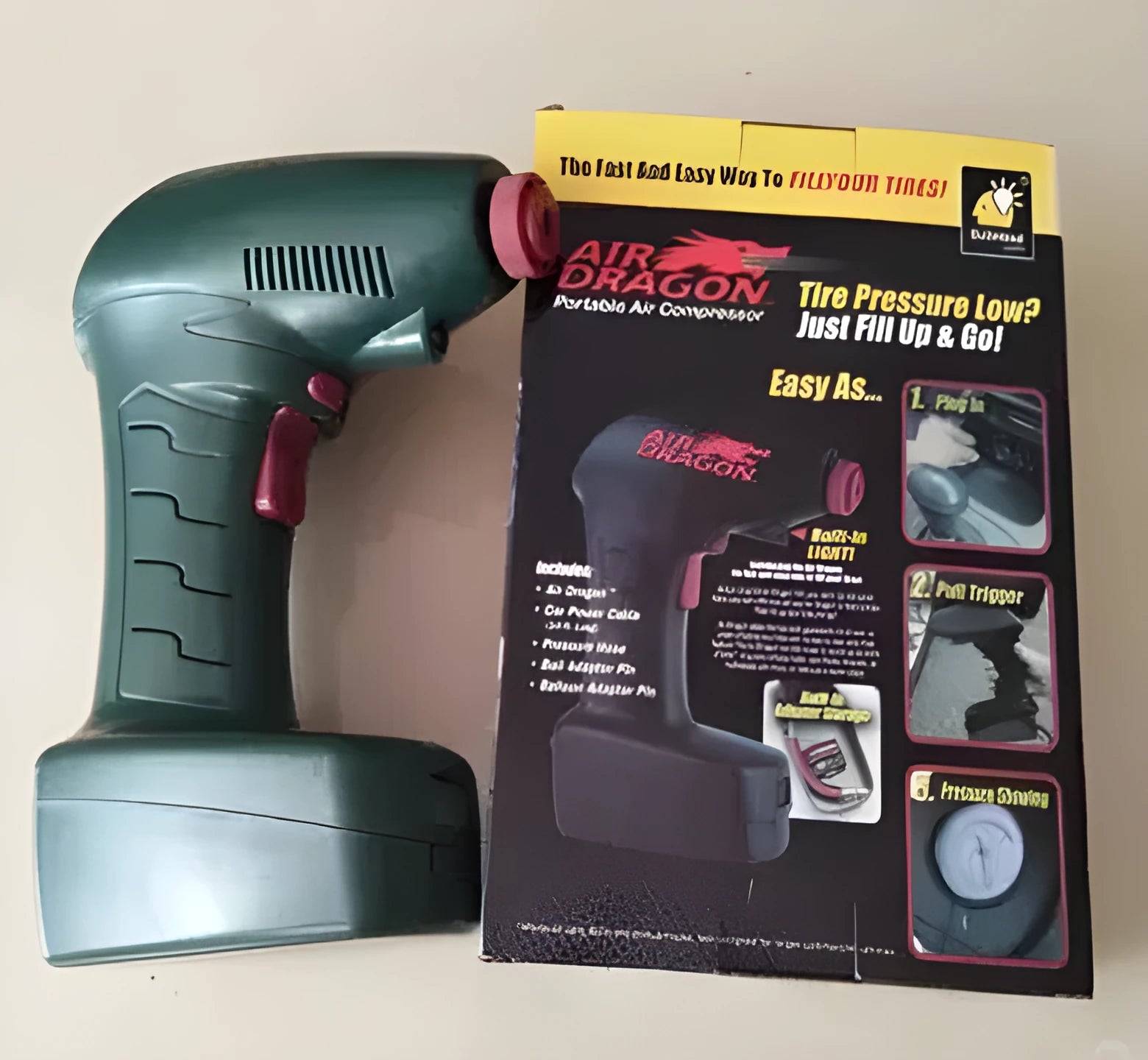 Portable car air pump with digital display and LED light showing 12V power connection and extended air hose