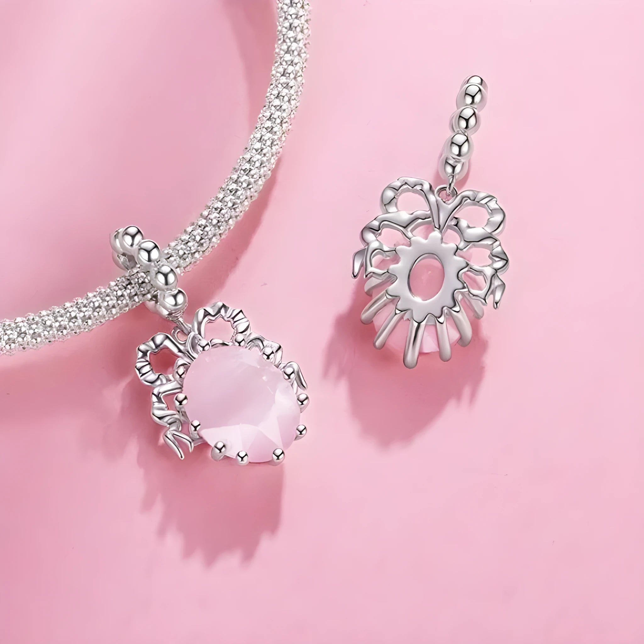 925 silver bow pendant with electroplated finish, height 2.4cm, width 1.2cm, on white background