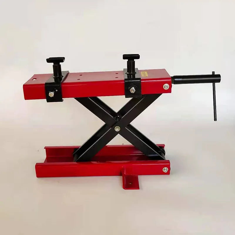 Red motorcycle support lift table raising a bike 16 inches above the ground for repair work