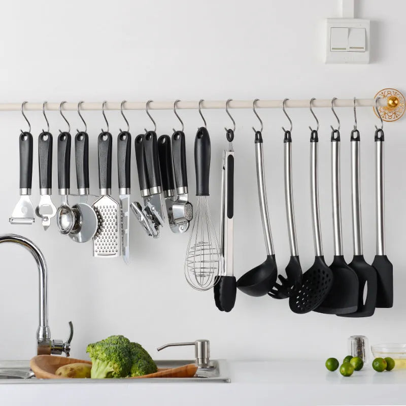 Black kitchen spatula and spoon set with stainless steel handles and silicone ends