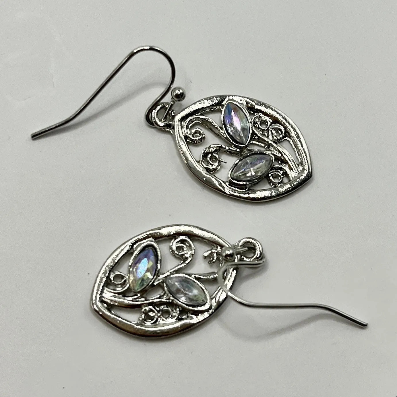 Silver colour leaf-shaped alloy earrings with embedded colourful moonstone centrepieces