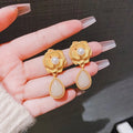 Gold colour stud earrings with rose pearl design, opal stones, and ice flower elements