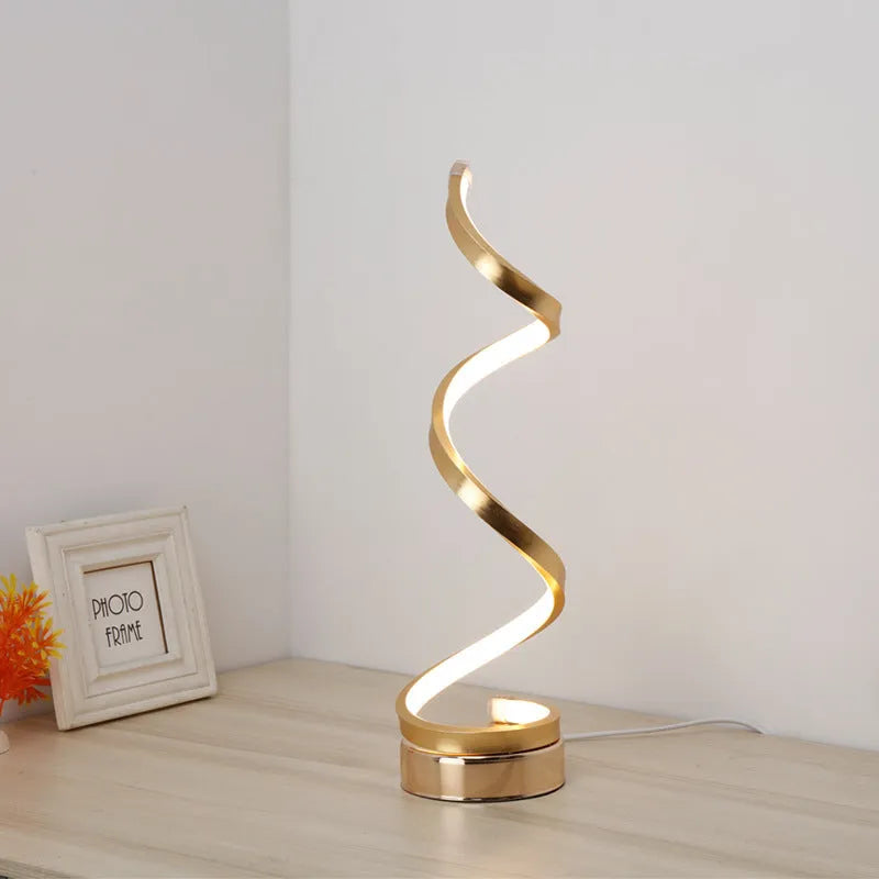 Black minimalist LED bedside table lamp with aluminium shade and metal base on wooden table