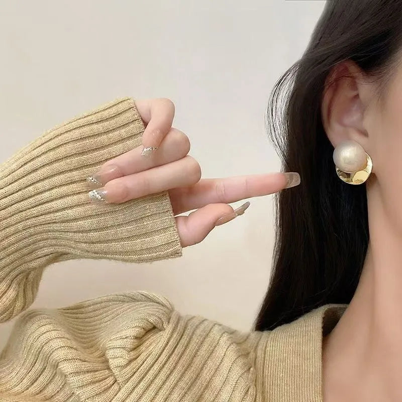 Alloy round stud earrings for women, casual style with metal finish, side view on model